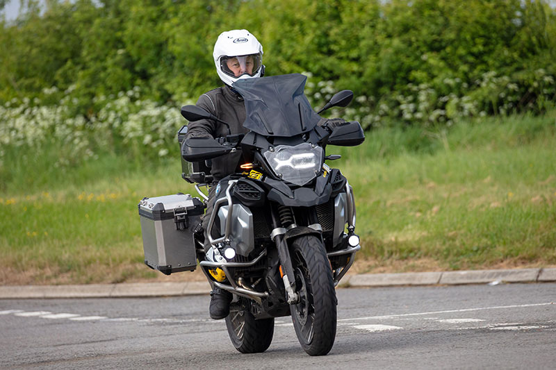 Guy riding BMW GS on road